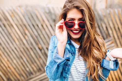 Girl smiling with heart glasses